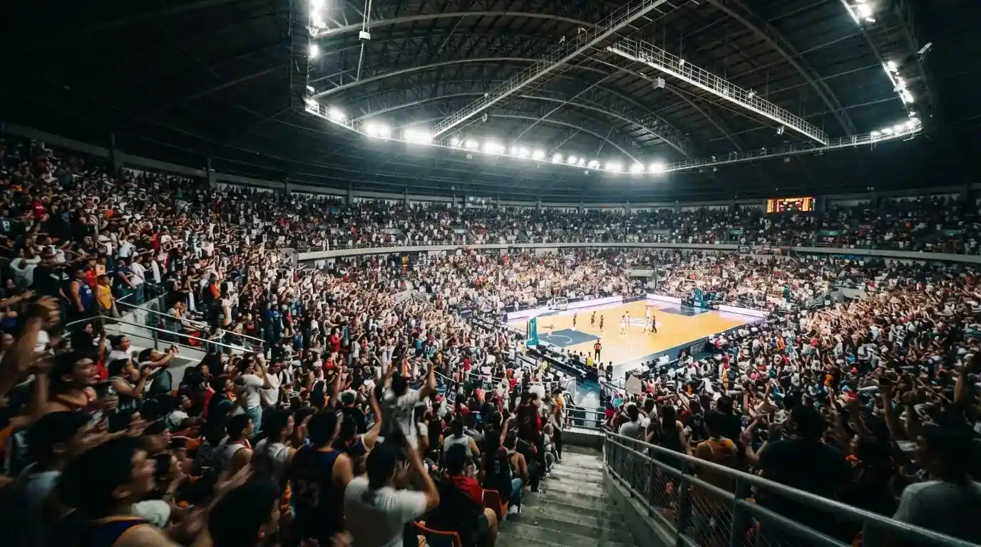 A packed sports hall under floodlights photographed from a long way off